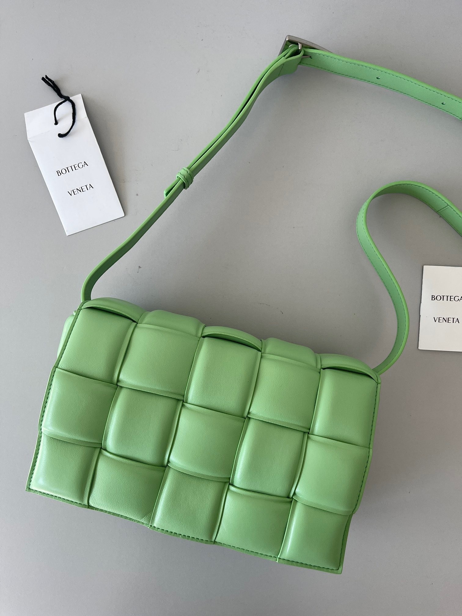 bo*te*ga Ve*ne*ta padded cassette bag in acid green lambskin