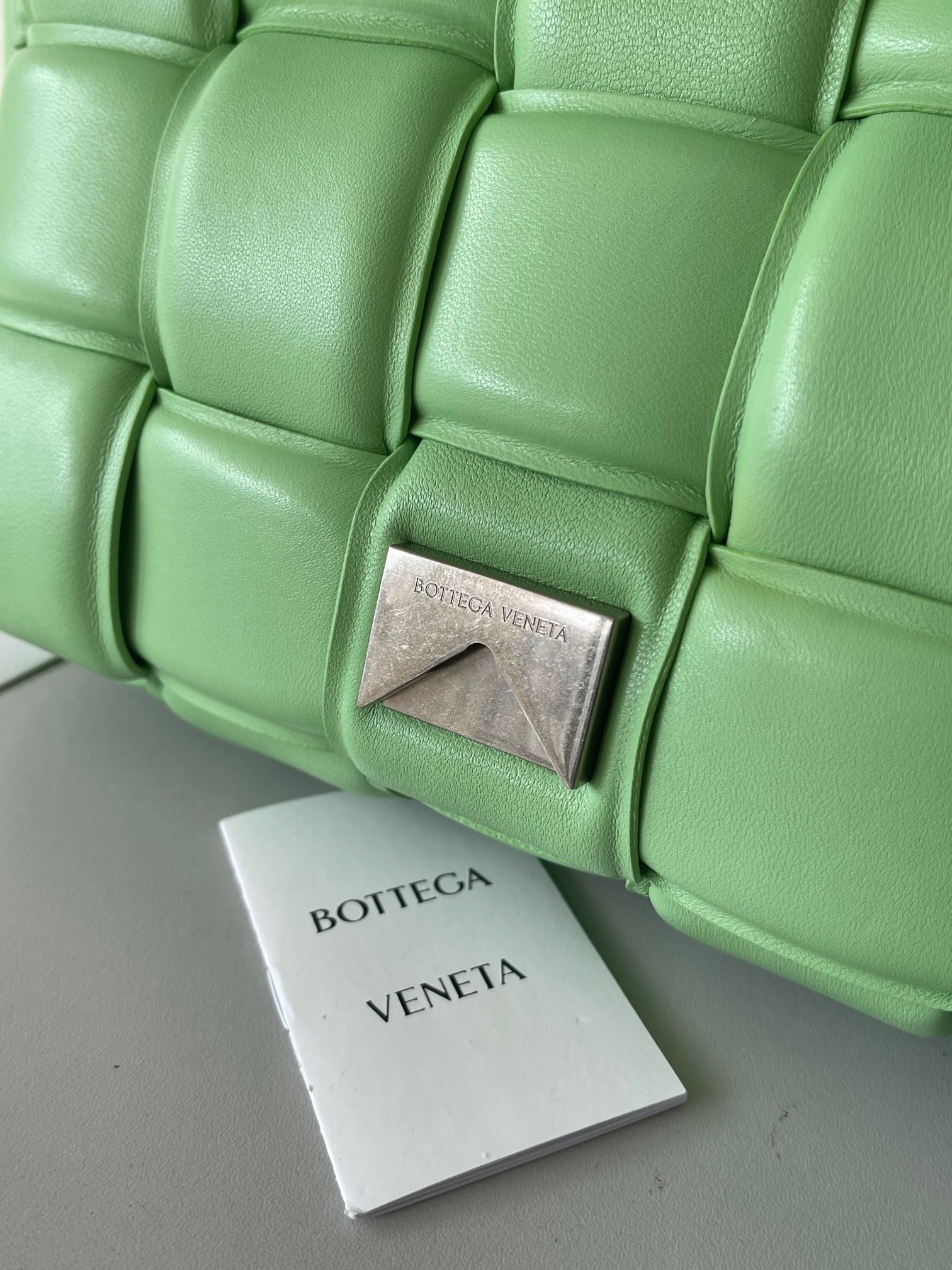 bo*te*ga Ve*ne*ta padded cassette bag in acid green lambskin