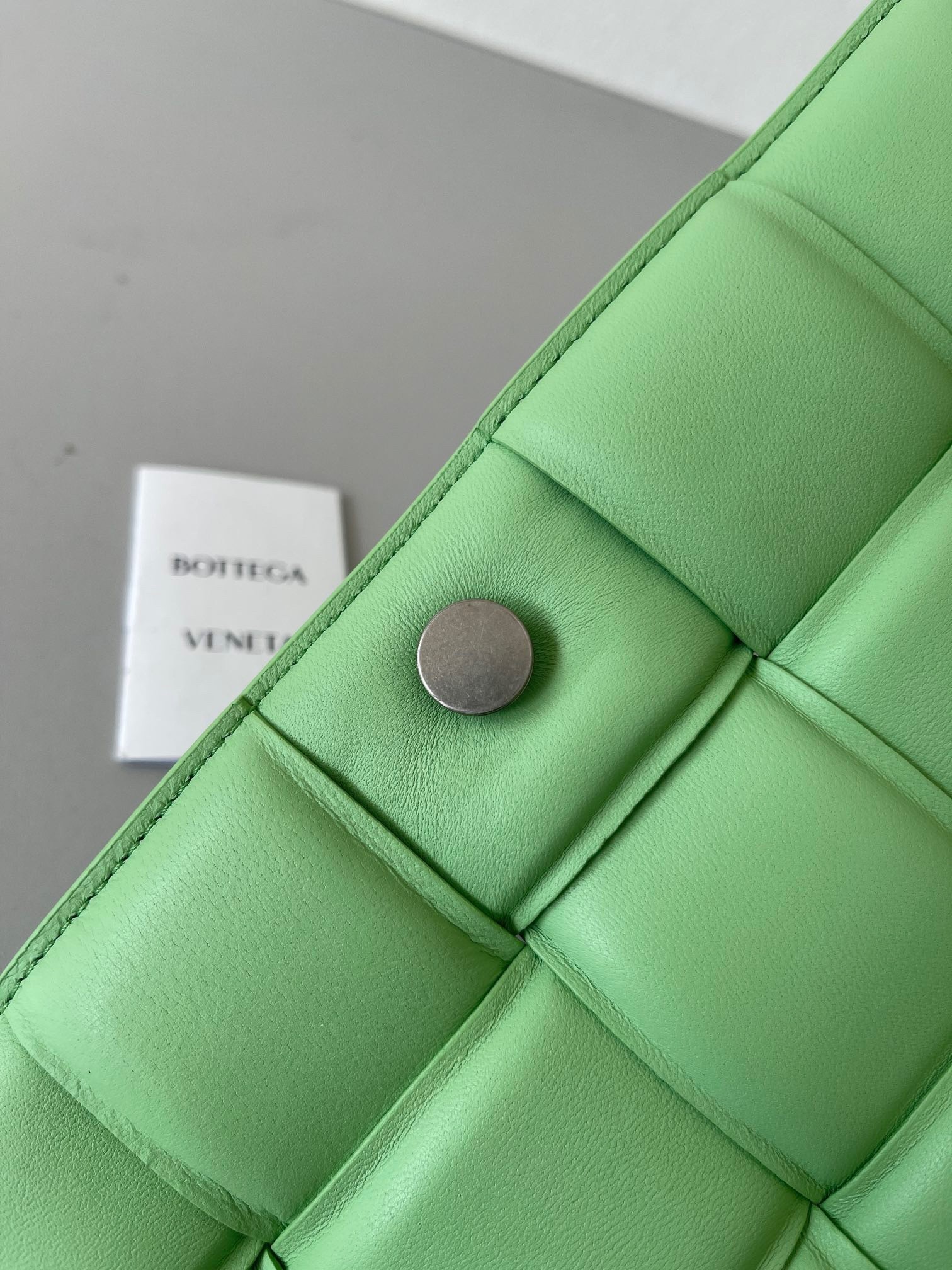 bo*te*ga Ve*ne*ta padded cassette bag in acid green lambskin