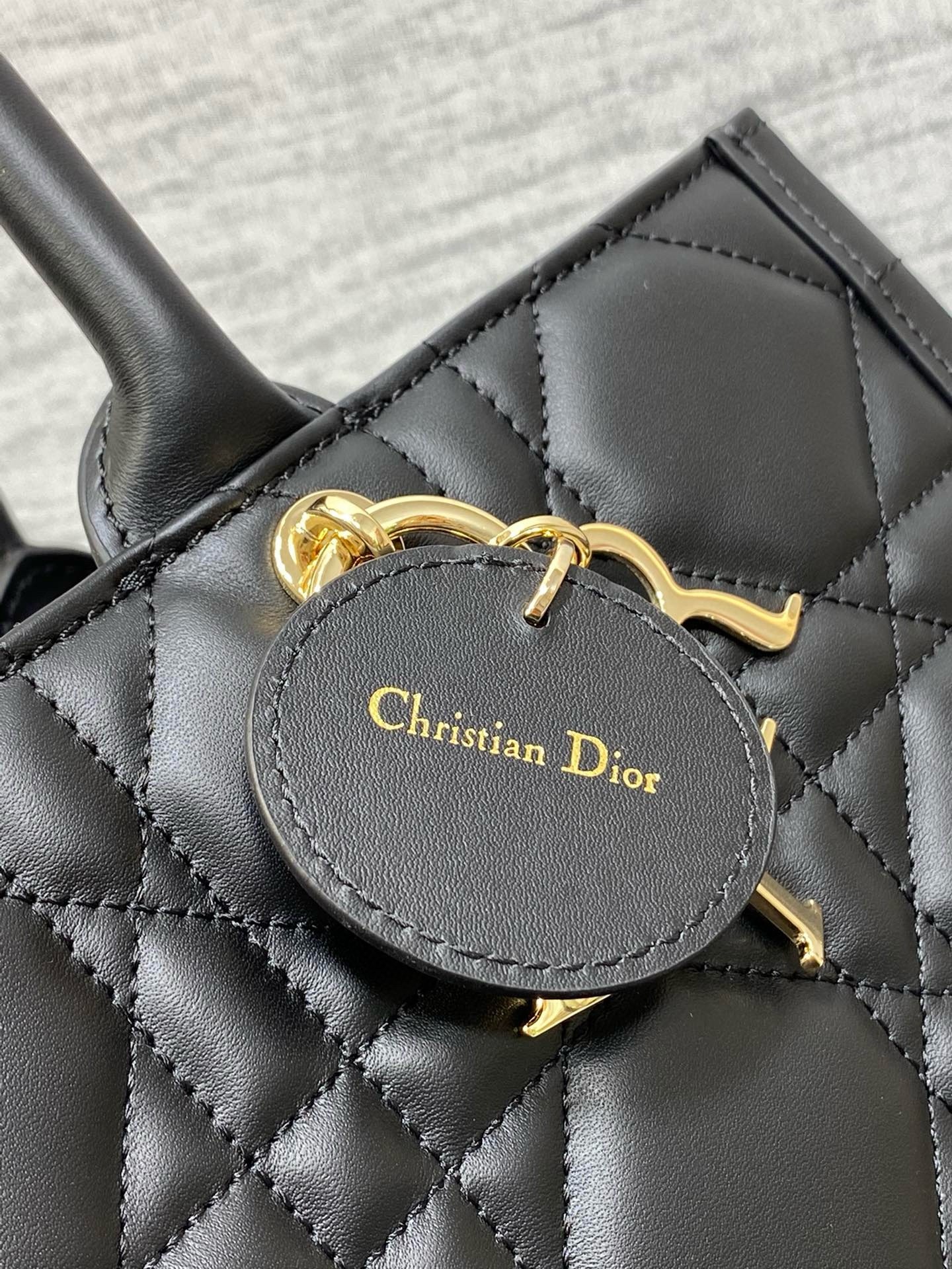 D*or medium book tote bag with strap in black macrocannage calfskin